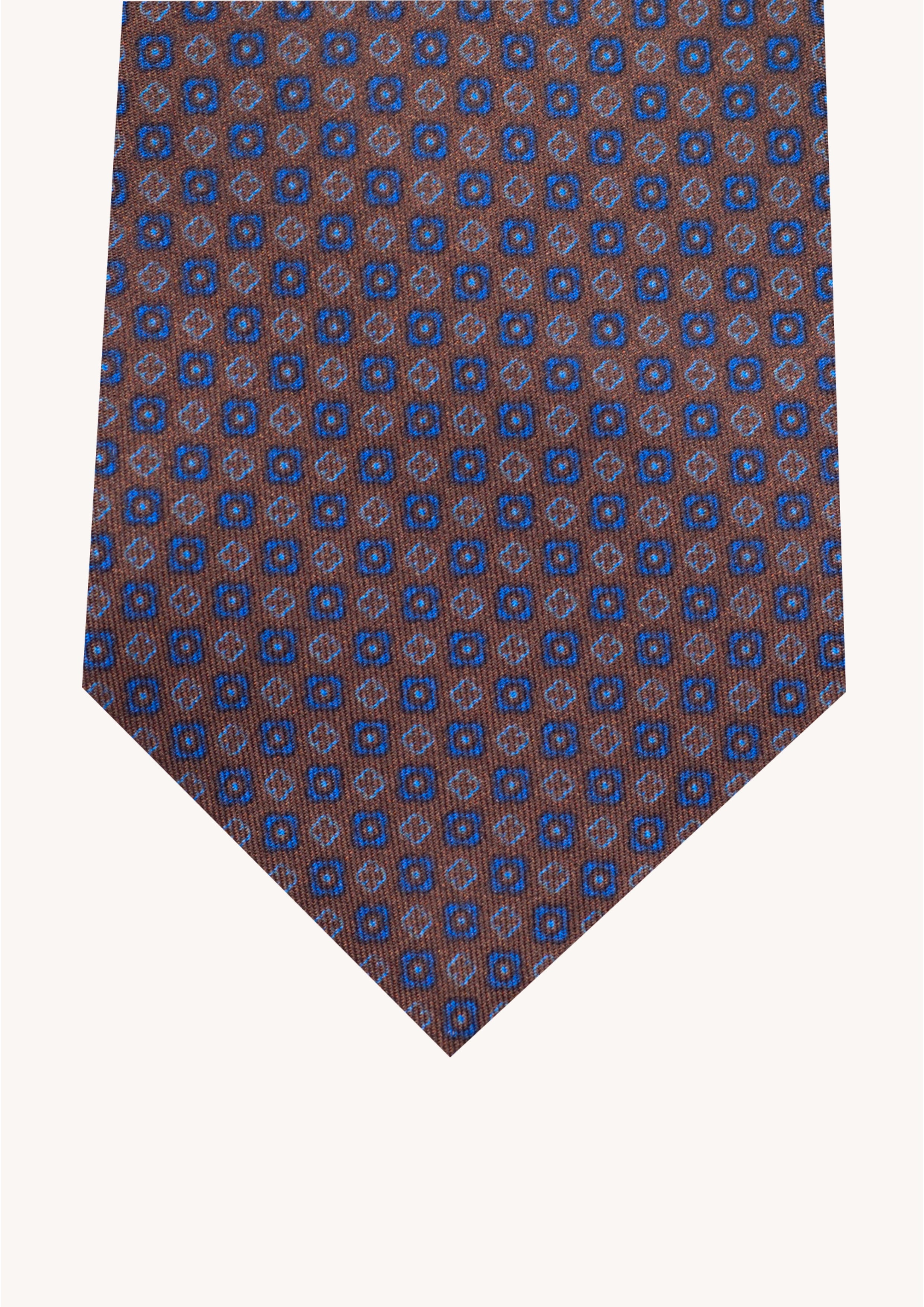 Cravate en twill 100% soie, ornée d'un motif de fleurs bleues sur fond marron