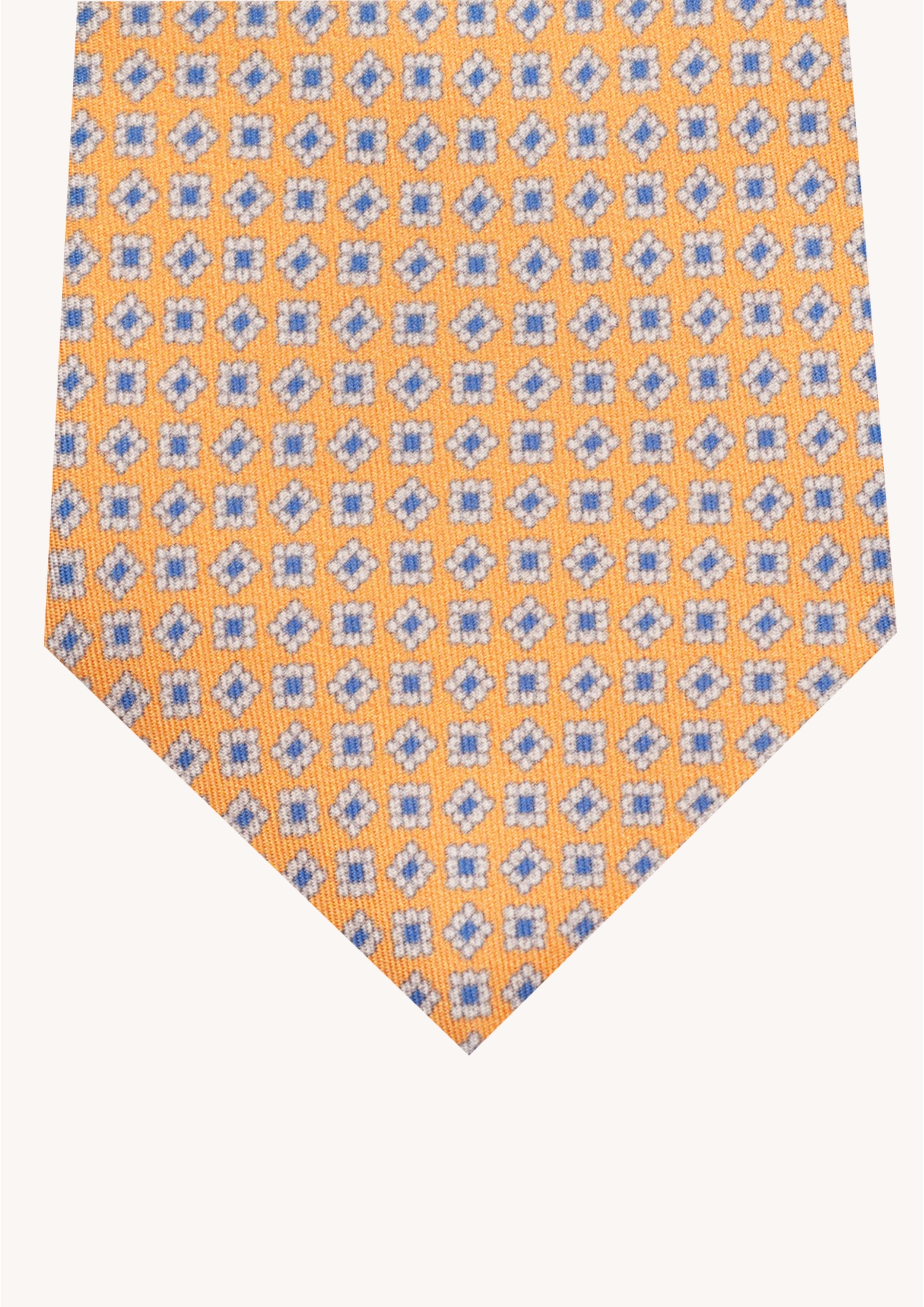 Cravate en twill 100% soie, ornée d'un motif de fleurs bleues et blanches sur fond orange