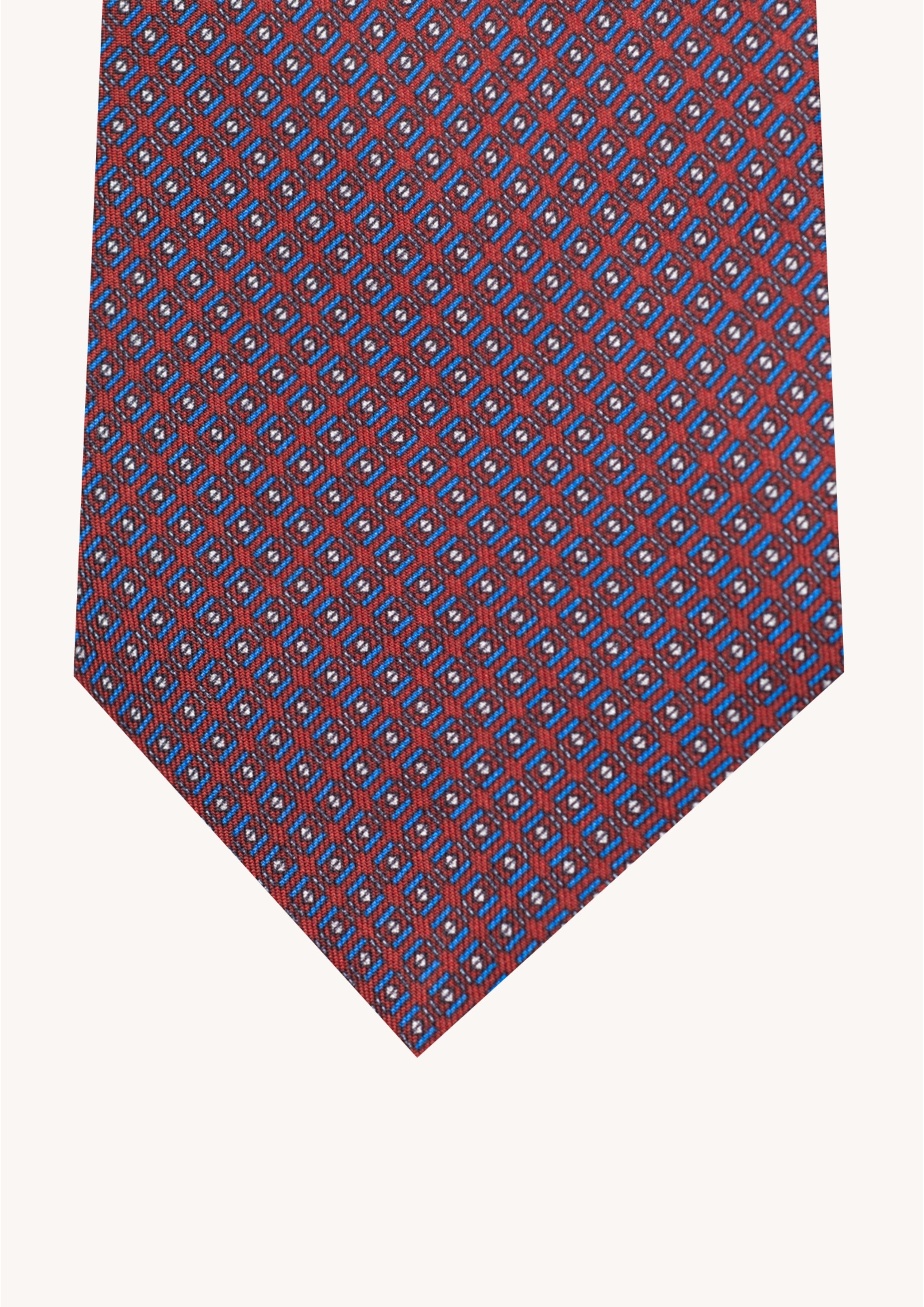 Cravate en twill 100% soie, ornée d'un motif géométrique bleu et blanc sur fond rouge
