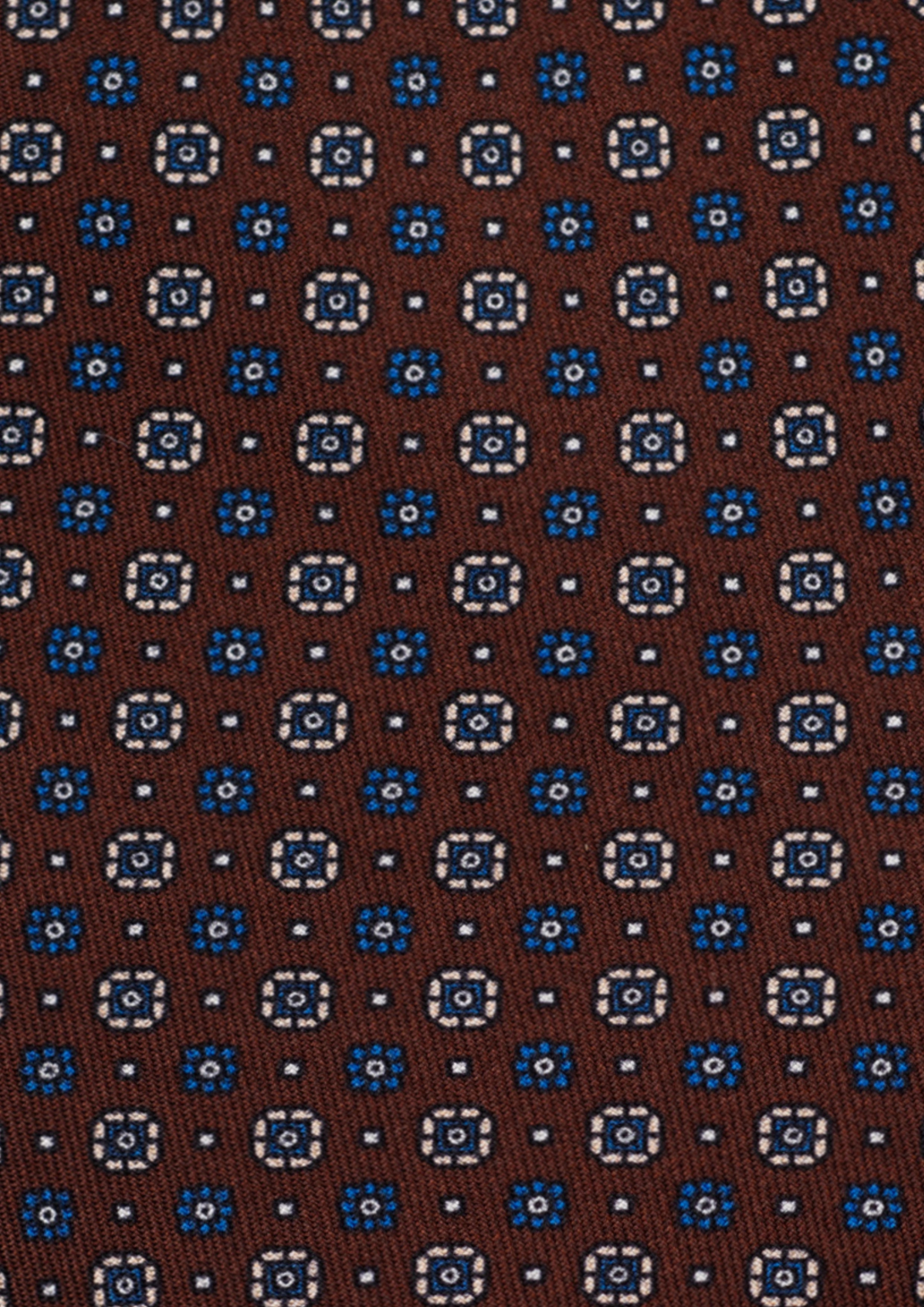 Cravate en twill 100% soie, ornée d'un motif de fleurs bleues et blanches sur fond marron