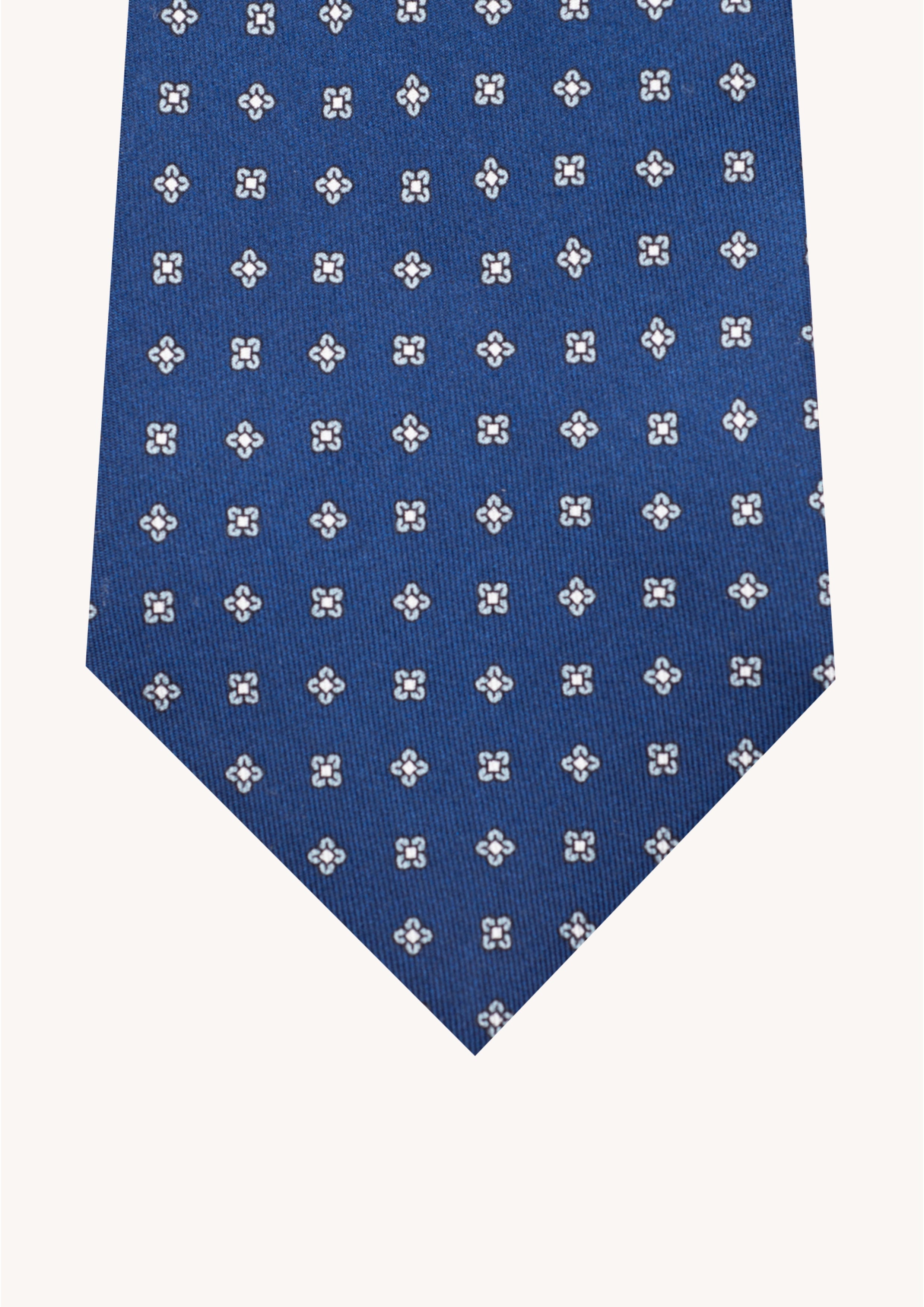 Cravate en twill 100% soie, ornée d'un motif de fleurs blanches sur fond bleu