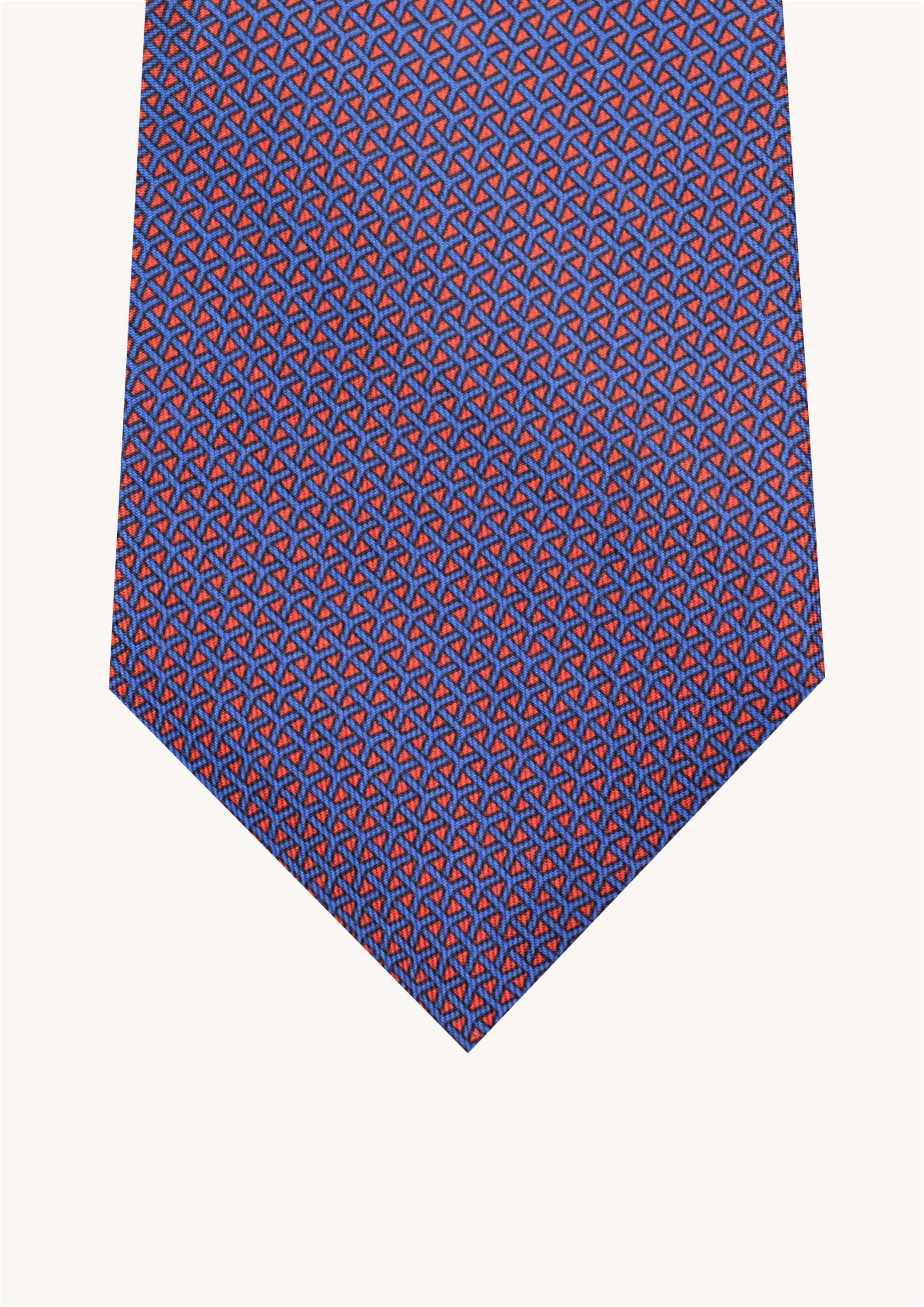 Cravate en twill 100% soie, ornée d'un motif géométrique bleu sur fond rouge
